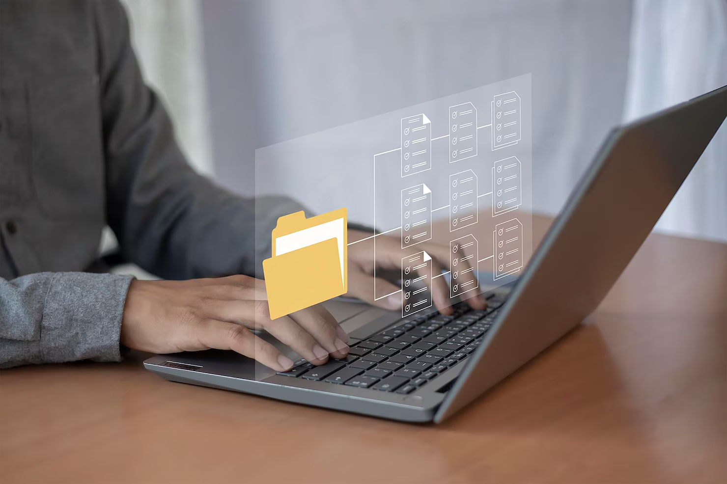 Person checking in laptop with digital file icons for document recognition.